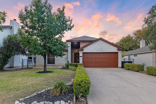 view of front of house with a yard and a garage