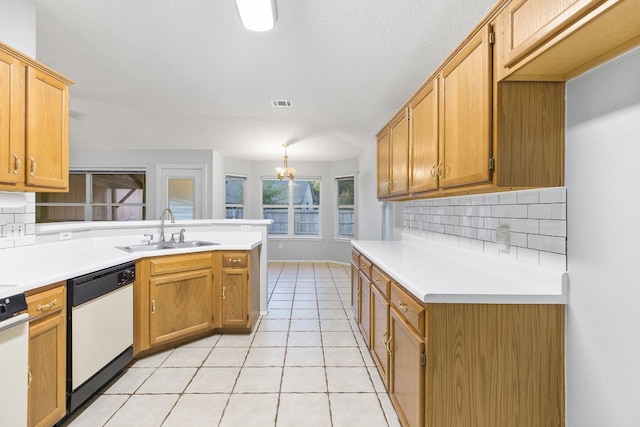 kitchen featuring tasteful backsplash, sink, light tile patterned flooring, white dishwasher, and an inviting chandelier