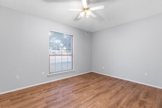 empty room featuring hardwood / wood-style floors, a textured ceiling, and ceiling fan