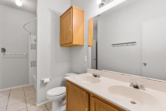 full bathroom with tile patterned floors, toilet, bathtub / shower combination, vanity, and a textured ceiling