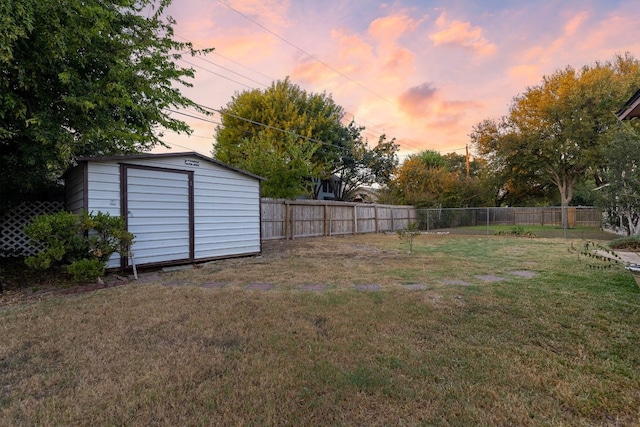 yard at dusk with a storage shed