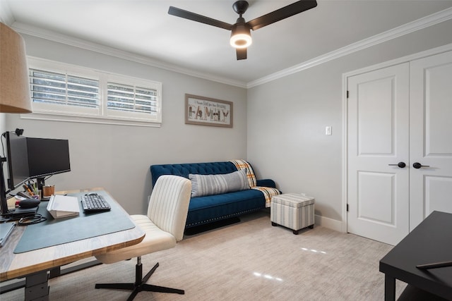 office area with ornamental molding, light colored carpet, and ceiling fan