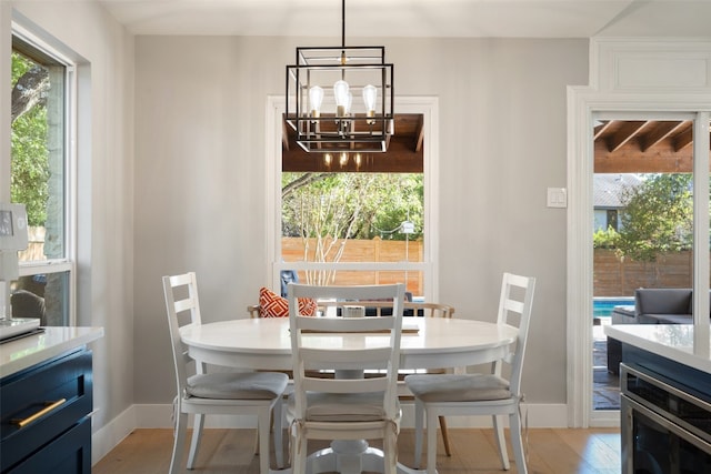 dining area with a notable chandelier and light wood-type flooring