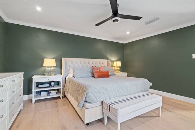 bedroom featuring ceiling fan, crown molding, and light hardwood / wood-style flooring