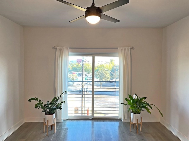 empty room featuring ceiling fan and dark hardwood / wood-style floors