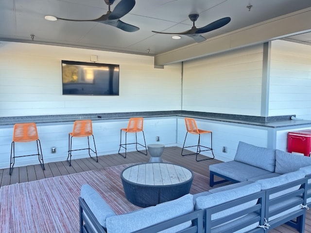 wooden terrace with ceiling fan and outdoor lounge area