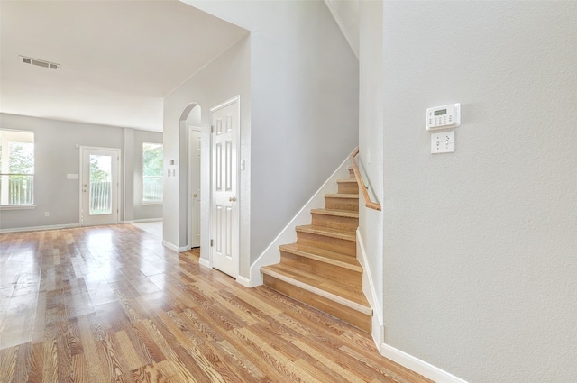 stairs with hardwood / wood-style floors