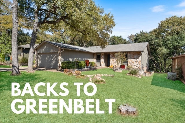 ranch-style house with a garage and a front yard