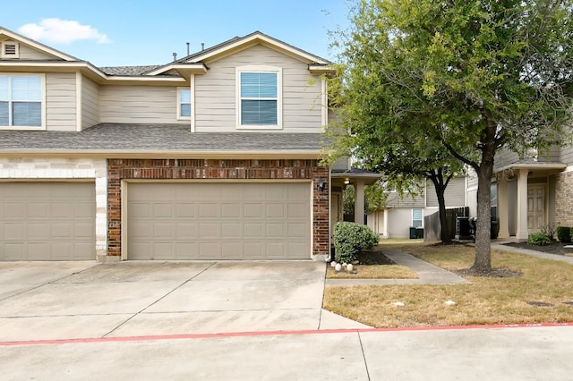 view of front of home featuring central AC and a garage