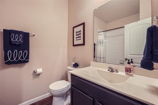 bathroom featuring vanity, hardwood / wood-style flooring, toilet, and walk in shower