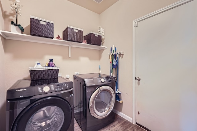 laundry area featuring hardwood / wood-style floors and washer and clothes dryer