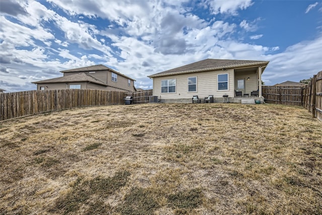 rear view of property with a patio area and central AC