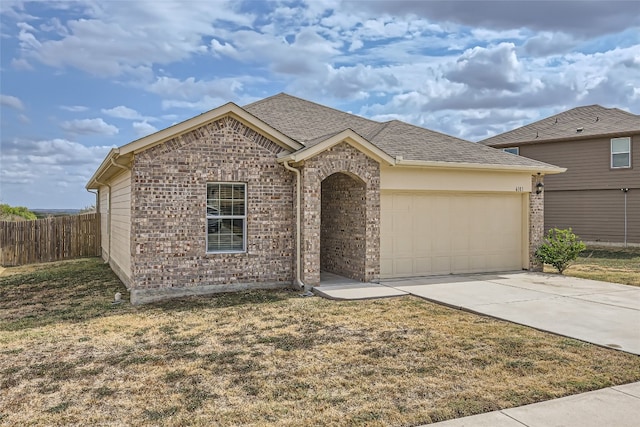 single story home featuring a front yard and a garage