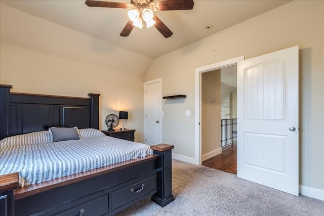 carpeted bedroom with ceiling fan and vaulted ceiling