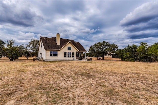 back of house with a yard