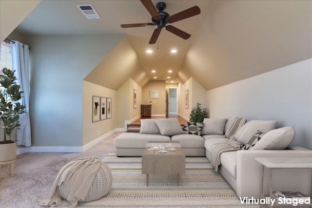 living room with ceiling fan, lofted ceiling, and light carpet