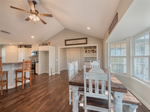 dining room featuring dark hardwood / wood-style floors, ceiling fan, and vaulted ceiling