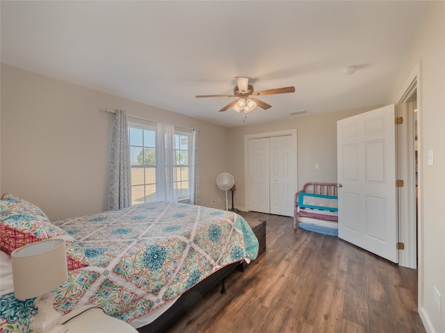 bedroom with a closet, dark hardwood / wood-style floors, and ceiling fan