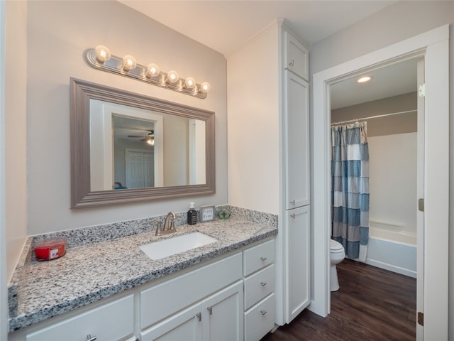 full bathroom featuring vanity, toilet, shower / bathtub combination with curtain, and hardwood / wood-style floors