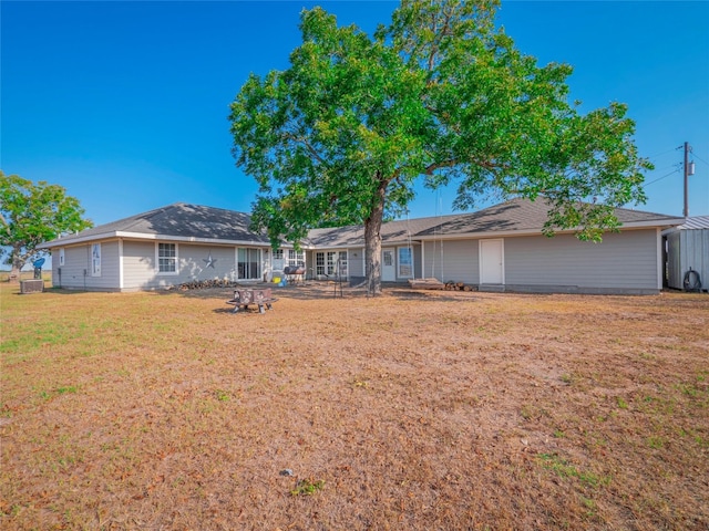 rear view of house featuring a lawn