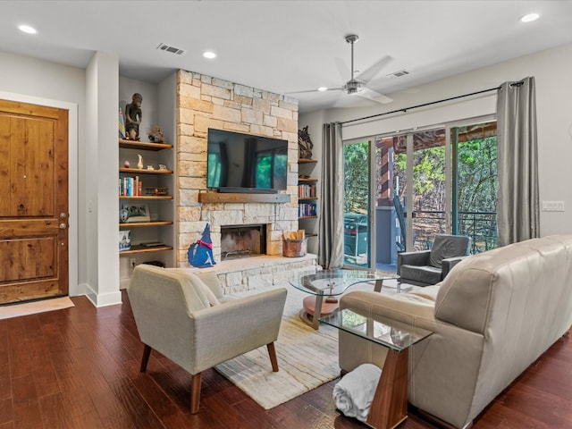 living room featuring ceiling fan, dark hardwood / wood-style flooring, and a fireplace