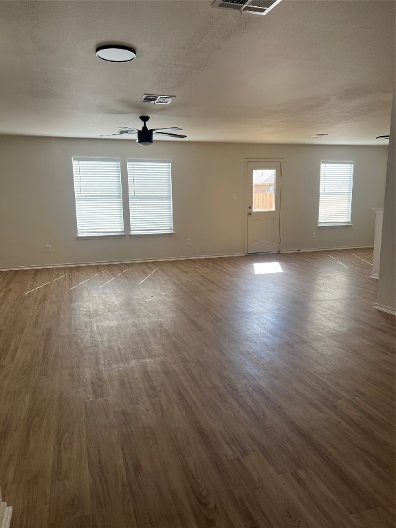 unfurnished room with ceiling fan and dark hardwood / wood-style floors