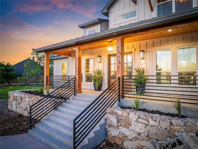 exterior entry at dusk with a porch