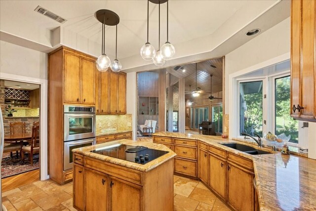 100 Silver Spur, Horseshoe Bay, TX 78657 - kitchen featuring stainless steel double oven, black electric cooktop, tasteful backsplash, and stone tile floors