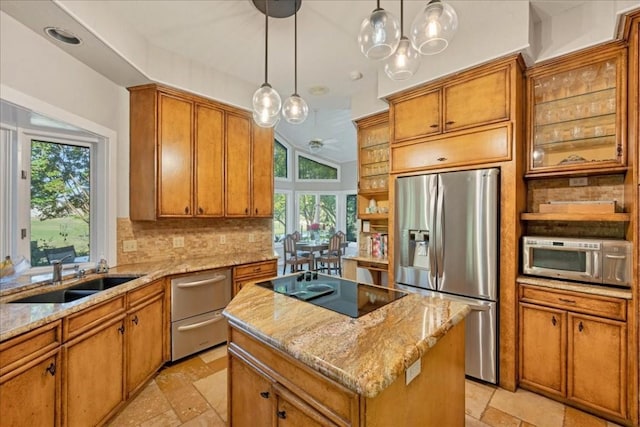 100 Silver Spur, Horseshoe Bay, TX 78657 - kitchen with stainless steel appliances, a sink, a center island, stone tile flooring, and brown cabinets
