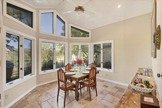 100 Silver Spur, Horseshoe Bay, TX 78657 - sunroom featuring stone tile floors, baseboards, and high vaulted ceiling