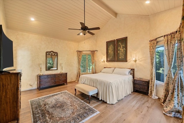 bedroom with vaulted ceiling with beams, light hardwood / wood-style flooring, multiple windows, and ceiling fan