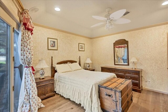 100 Silver Spur, Horseshoe Bay, TX 78657 - bedroom with light wood finished floors, ornamental molding, a ceiling fan, wallpapered walls, and baseboards
