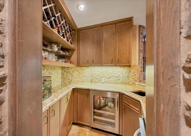 100 Silver Spur, Horseshoe Bay, TX 78657 - indoor wet bar featuring wine cooler and decorative backsplash