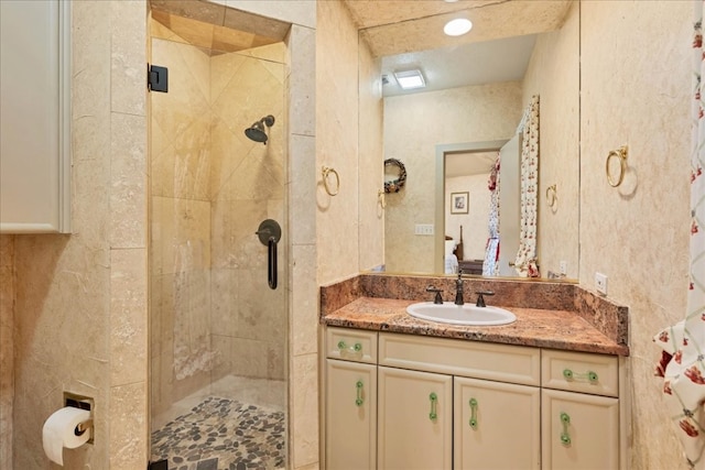 bathroom with vanity and a shower with shower door