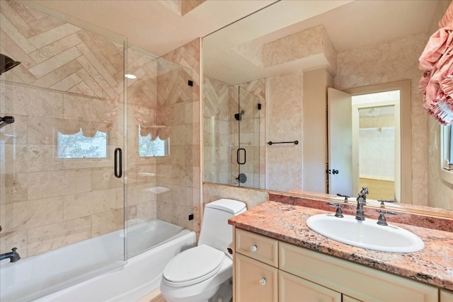 full bathroom with shower / bath combination with glass door, vanity, and toilet