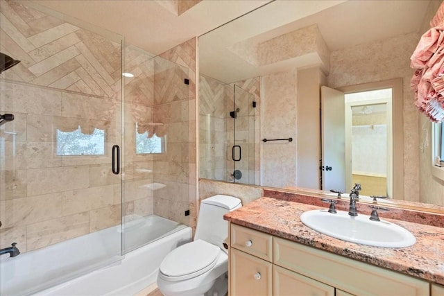 100 Silver Spur, Horseshoe Bay, TX 78657 - bathroom featuring shower / bath combination with glass door, vanity, and toilet