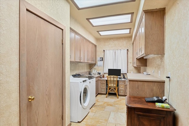 clothes washing area with washing machine and clothes dryer and cabinets