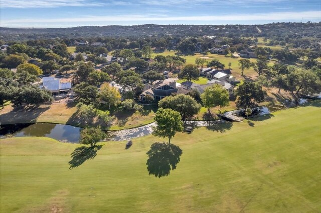 100 Silver Spur, Horseshoe Bay, TX 78657 - aerial view of property and surrounding area featuring a golf course, a nearby body of water, and nearby suburban area