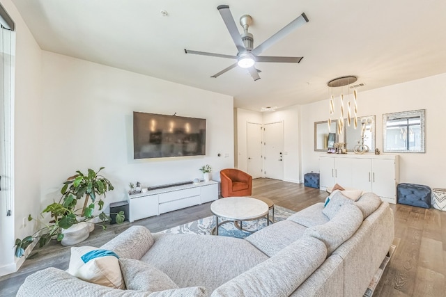 living room with ceiling fan and wood-type flooring