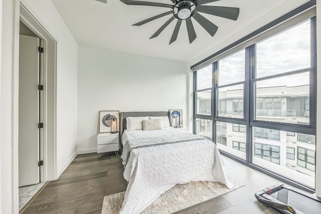 bedroom with ceiling fan and dark hardwood / wood-style floors