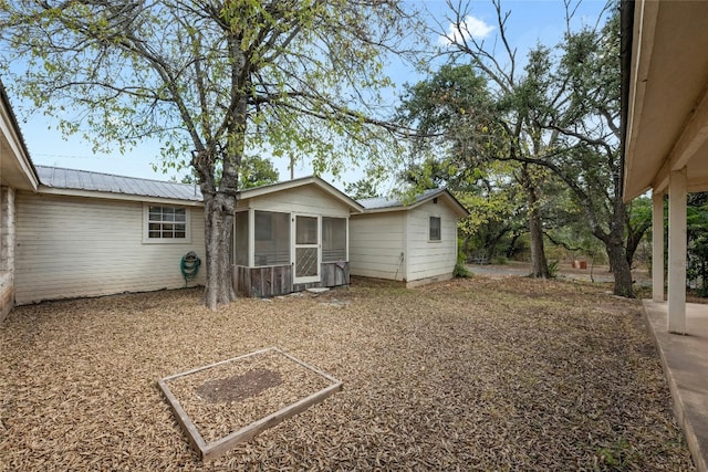 back of property with a sunroom