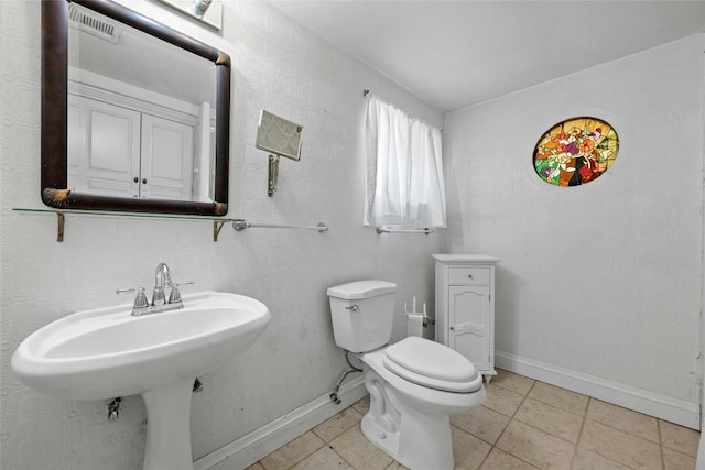 bathroom featuring toilet and tile patterned floors