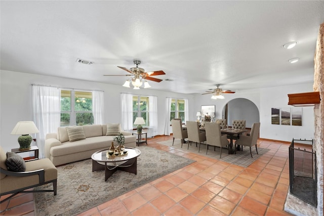 living room featuring ceiling fan and light tile patterned floors