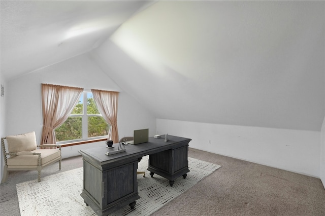 carpeted office featuring lofted ceiling