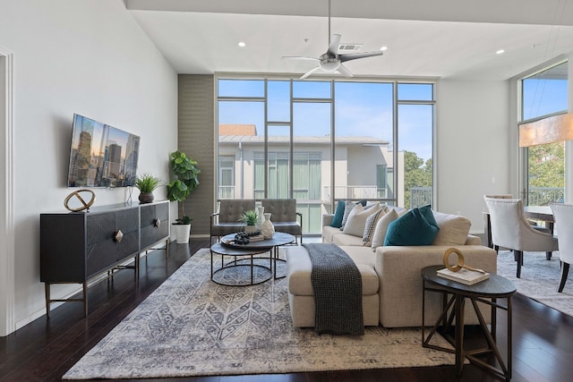 living room featuring a wall of windows, dark wood-type flooring, and ceiling fan