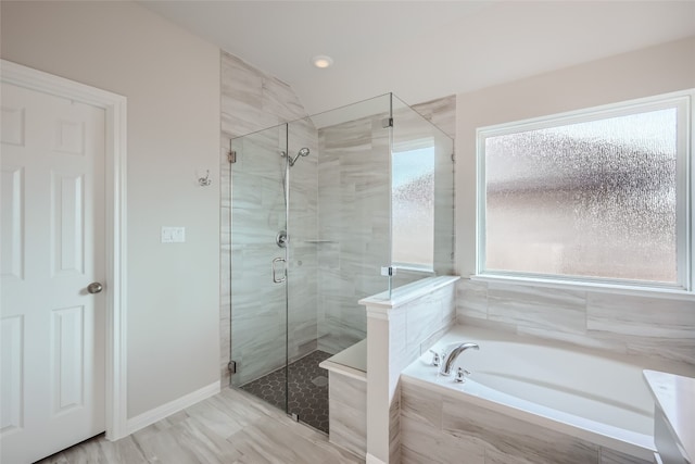 bathroom with shower with separate bathtub