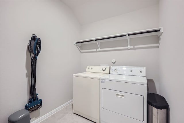 washroom with washer and dryer and light tile patterned floors