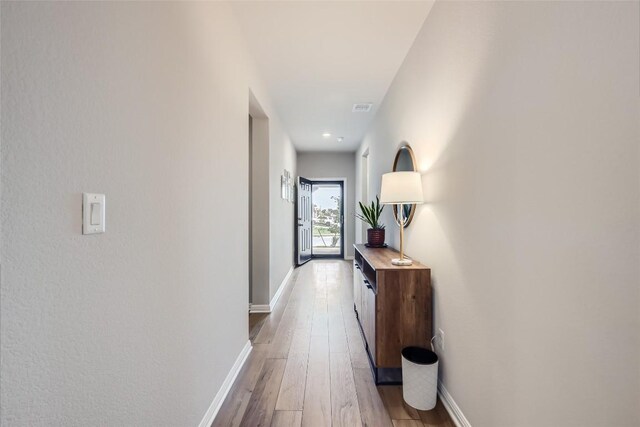 hallway with wood-type flooring