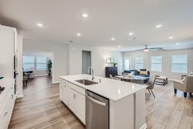 kitchen featuring light hardwood / wood-style flooring, sink, an island with sink, and stainless steel appliances