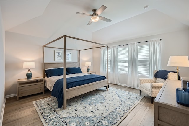 bedroom featuring ceiling fan, lofted ceiling, and light hardwood / wood-style flooring